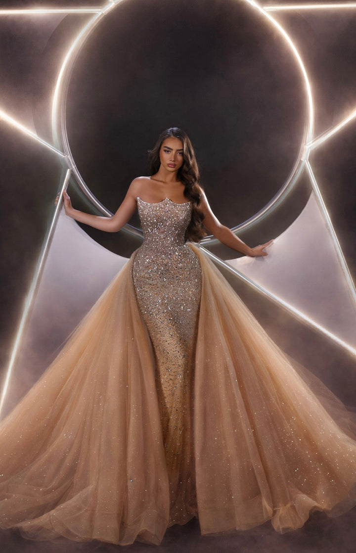Delilah LD21176 Strapless Sequin Mermaid Gown with Glitter Full Overskirt - Champagne front view