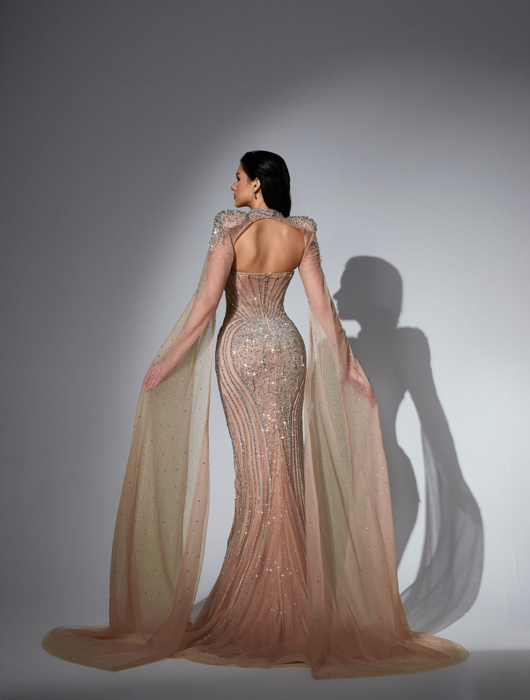 Delilah LD11478 Strapless Beaded Corset Mermaid Gown with Choker Capelet and Floor-Length Cape Sleeves - Champagne back view