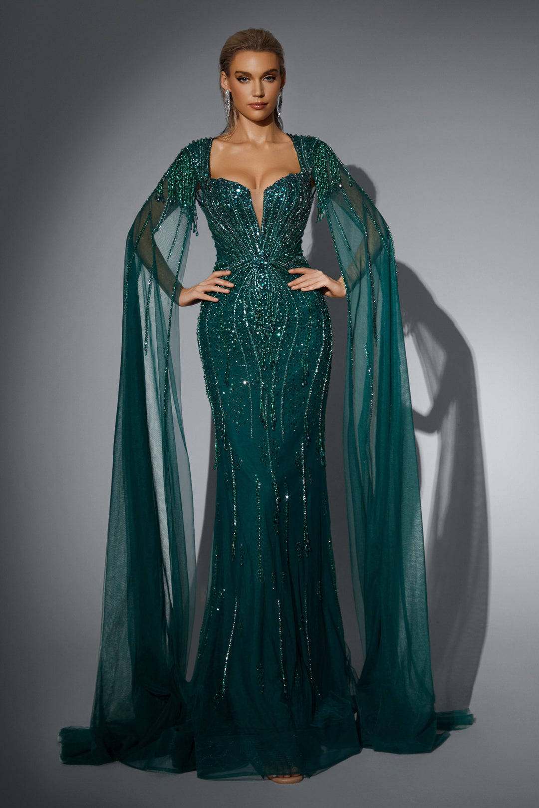 Delilah HM329 Plunging Sweetheart Beaded Mermaid Gown with Crystal Fringe Straps and Cape Sleeves - Emerald front view