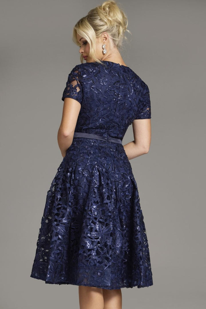 "Elevate your evening look with the Jovani 39427 homecoming dress. Featuring a charming V-neck, delicate lace overlay, short sleeves, and a trendy belt, this knee-length A-line dress is perfect for any event. Shop party perfection at FOSTANI!"